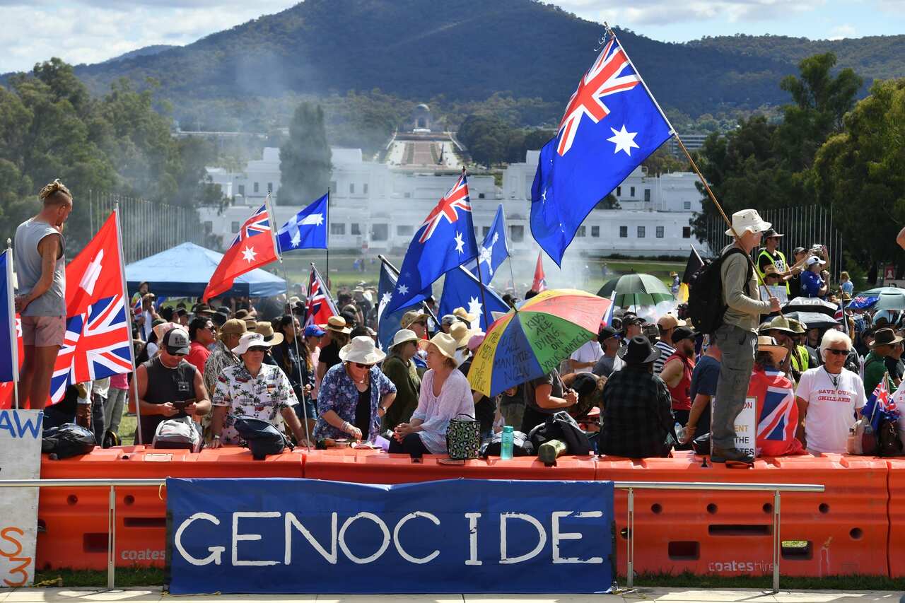 Convoy to Canberra protesters wave flags and banners during a protest outside Parliament House in Canberra.