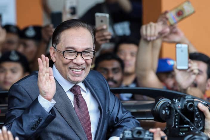 Malaysian opposition leader Anwar Ibrahim reacts as he leaves a rehabilitation centre in Kuala Lumpur.