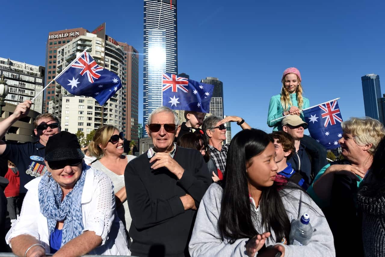 Crowds waving Australian flags watch veterans march to the Shrine of Remembrance for the Anzac Day march in Melbourne (AAP)
