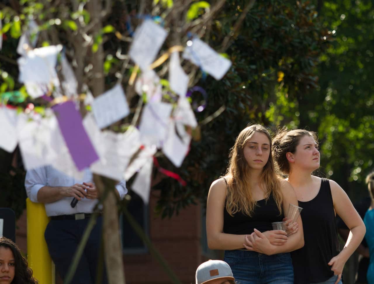 Mourners wrote notes and attached them to a tree at a memorial for Georgia Tech student Scout Schultz