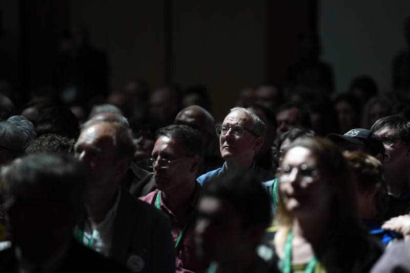 People react as they watch Australian Prime Minister Scott Morrison deliver the National Apology.
