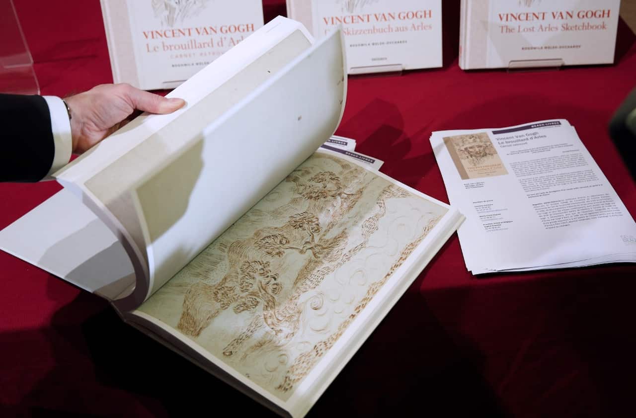 A person browses a copy of the book 'Vincent Van Gogh: The Lost Arles Sketchbook' (AAP)