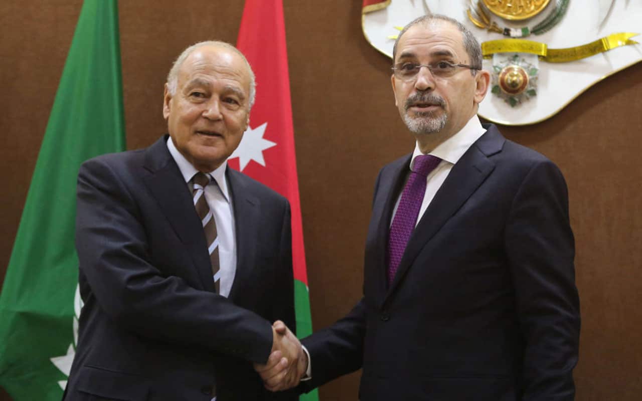 Jordanian Foreign Minister Ayman Safadi (R) shakes hands with Arab League chief Ahmed Abul Gheit.