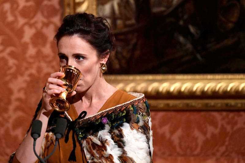 Ms Ardern sips on a drink as she delivers a speech at a dinner hosted by Queen Elizabeth II, during the Heads of Government Meeting at Buckingham Palace.