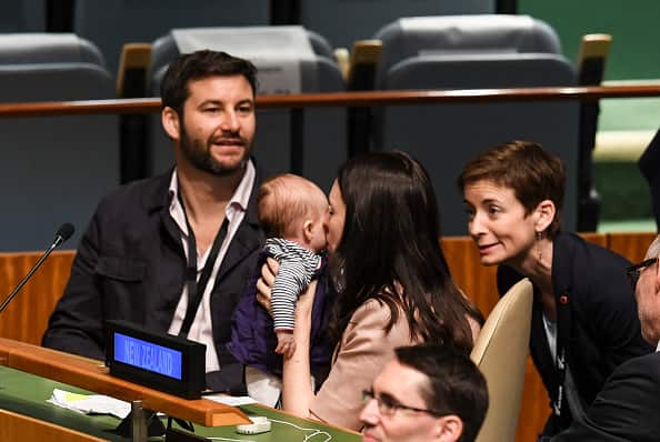 Mum and bub share a cuddle after the NZ PM addressed the meeting.