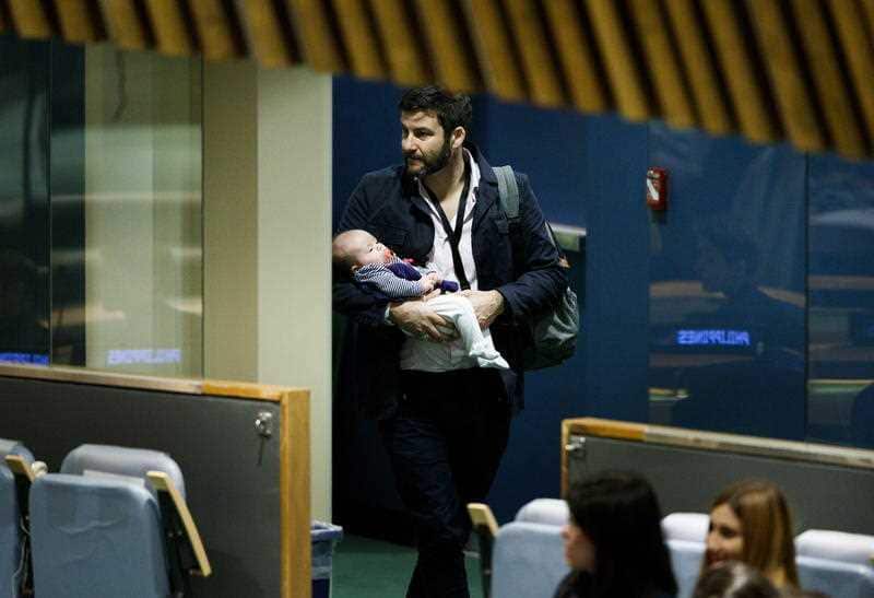 Dad on duty:  Clarke Gayford, partner of New Zealand Prime Minister Jacinda Ardern, carries their daughter Neve.