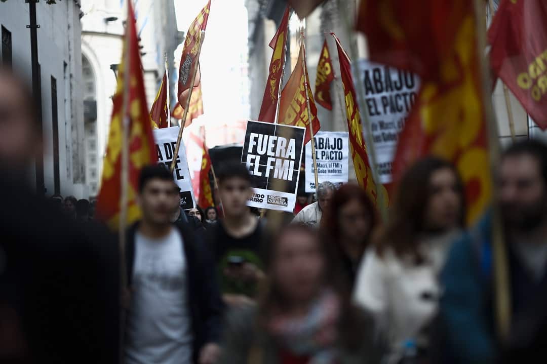 Dozens of protesters march outside the Central Bank, in Buenos Aires. 