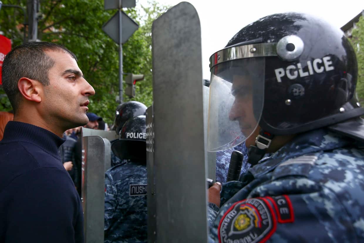 Police block demonstrators gathered to protest the former president's shift into the prime minister's seat in Yerevan, Armenia, on Saturday.