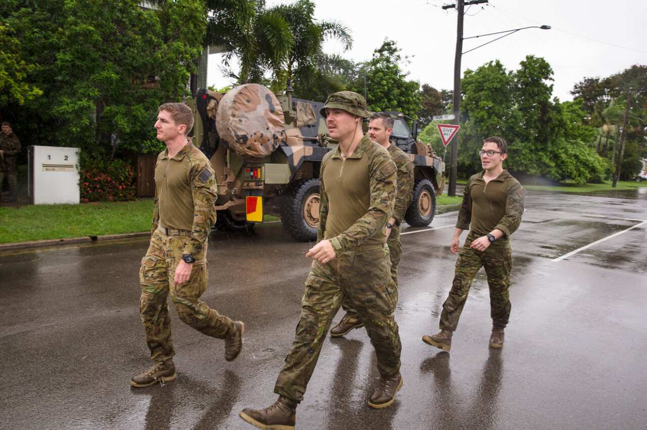 Army personal are seen assisting with flood evacuations in Rosslea, Townsville,