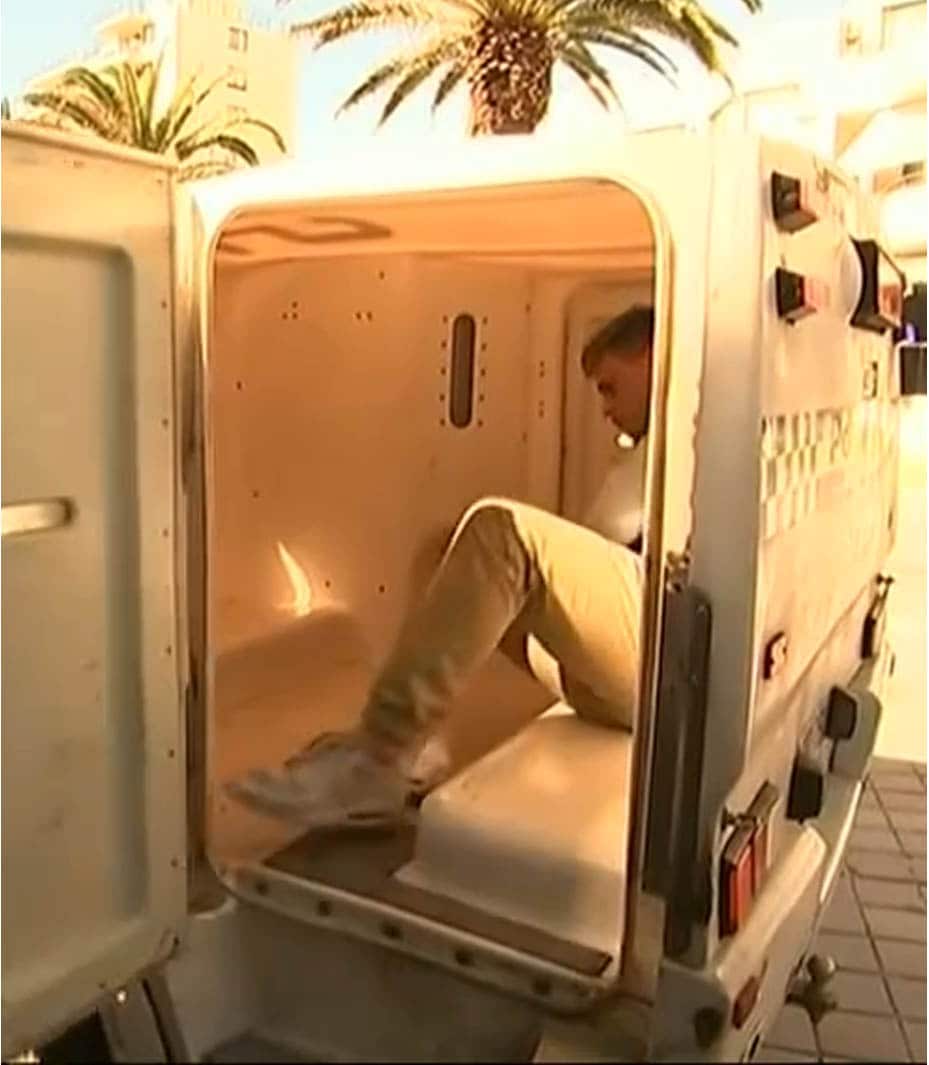 The 19-year-old is loaded into a waiting paddy wagon.