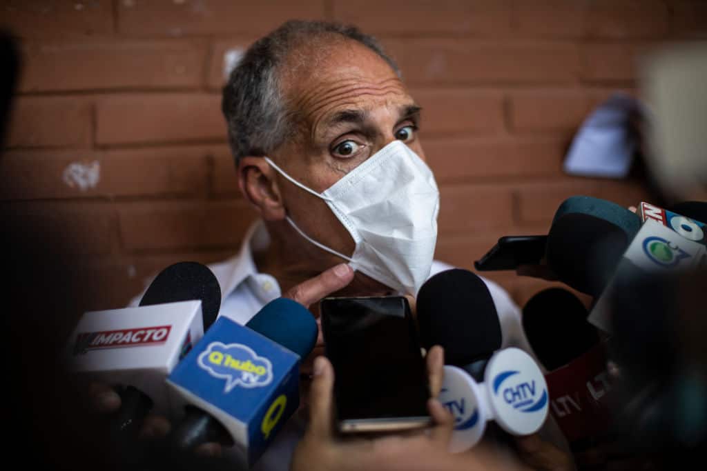 Presidential Candidate of the ruling National Party, Nasry Asfura, talks to journalists before casting his vote.