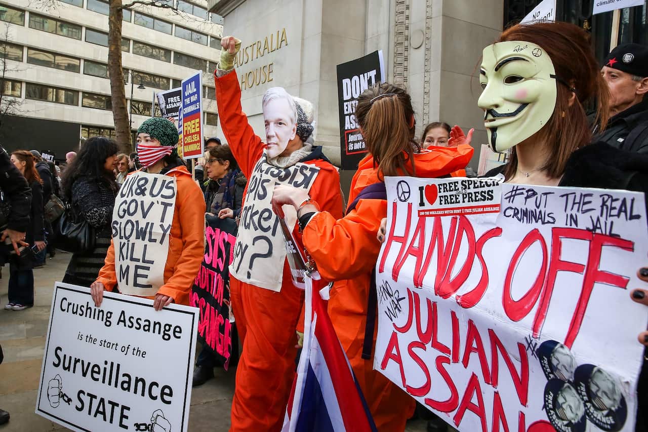 Supporters of Wikileaks Founder Julian Assange hold placards as they protest outside Australia House in central London.