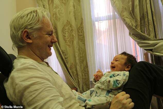 Mr Assange with his son. 