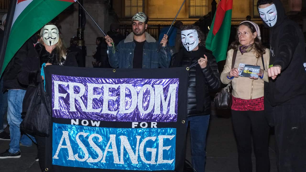 Protesters hold a a sign in support of Wikileaks founder Julian Assange in Trafalgar Square London.
