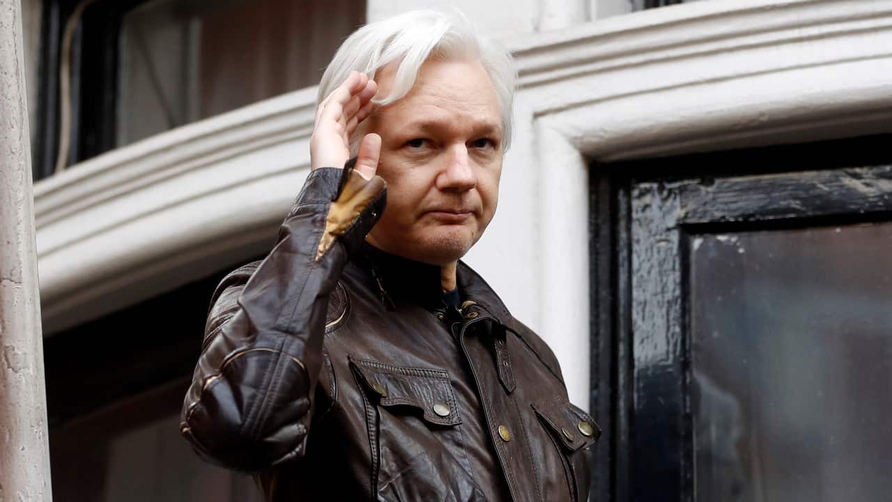WikiLeaks founder Julian Assange greets supporters from a balcony of the Ecuadorian embassy in London.