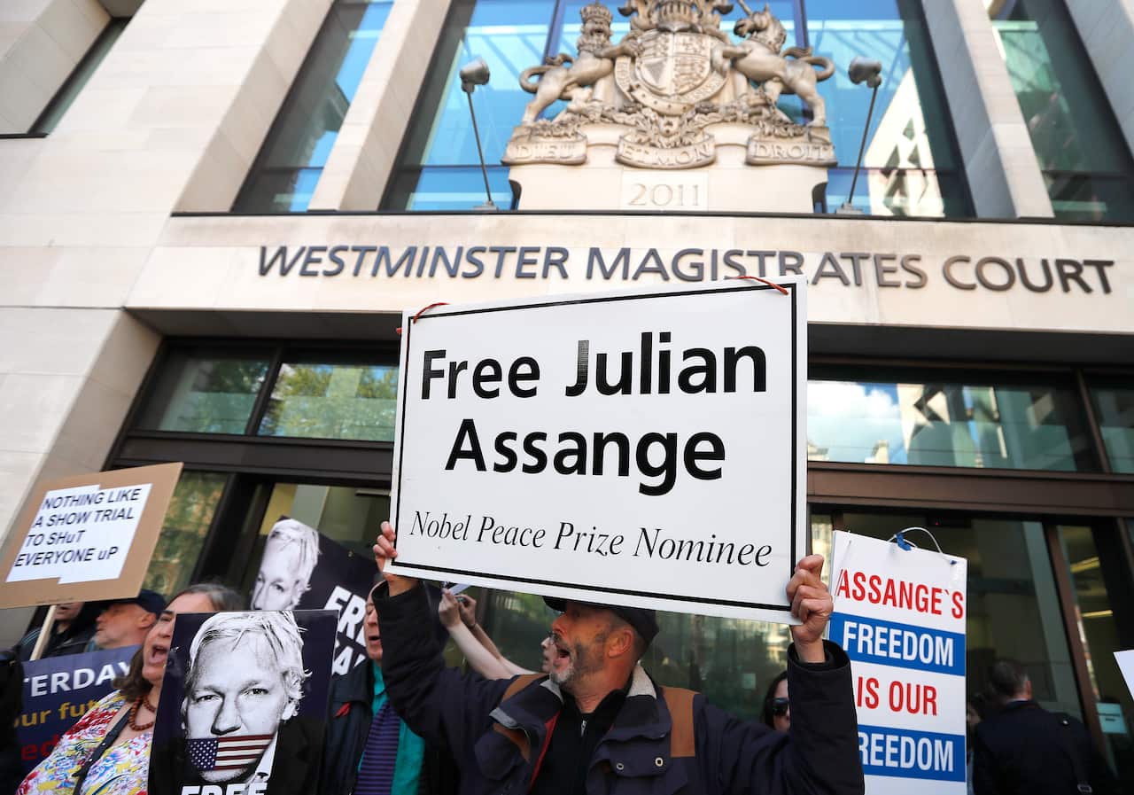 Protestors demonstrate at the entrance of Westminster Magistrates Court in London, ahead of Assange's hearing.