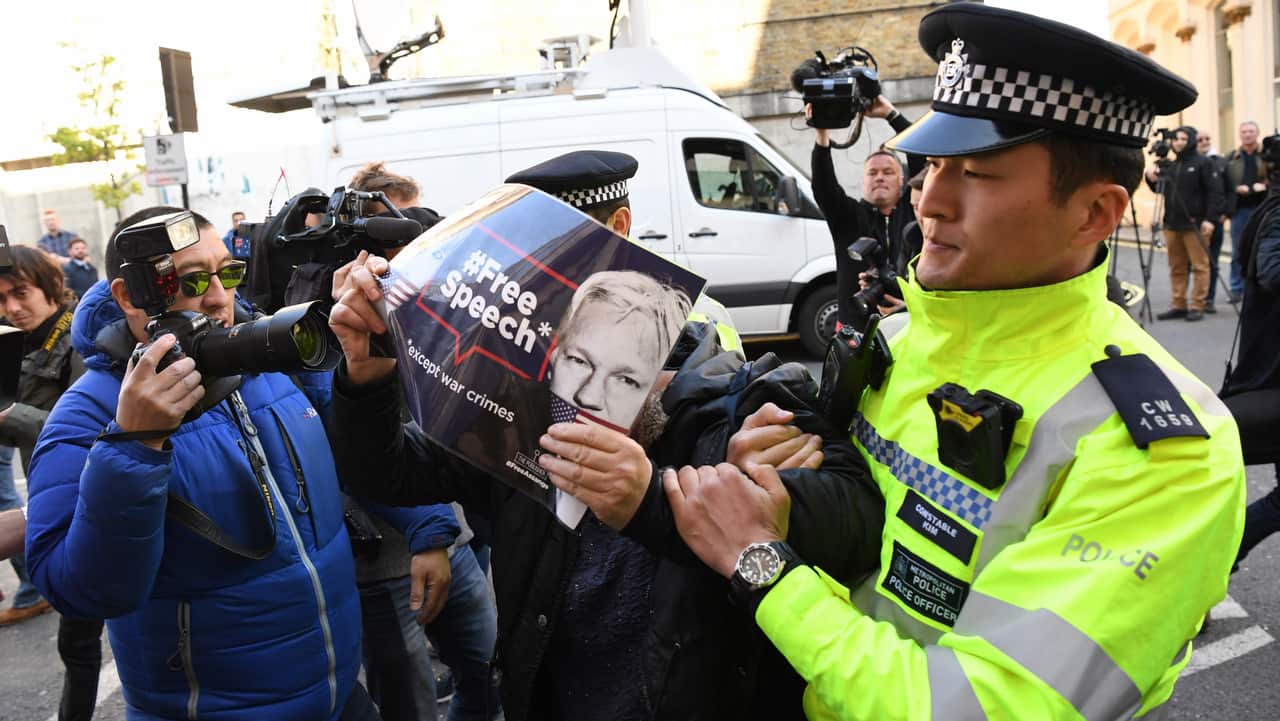 A protester scuffles with police outside of the Westminister Magistrates Court, London.