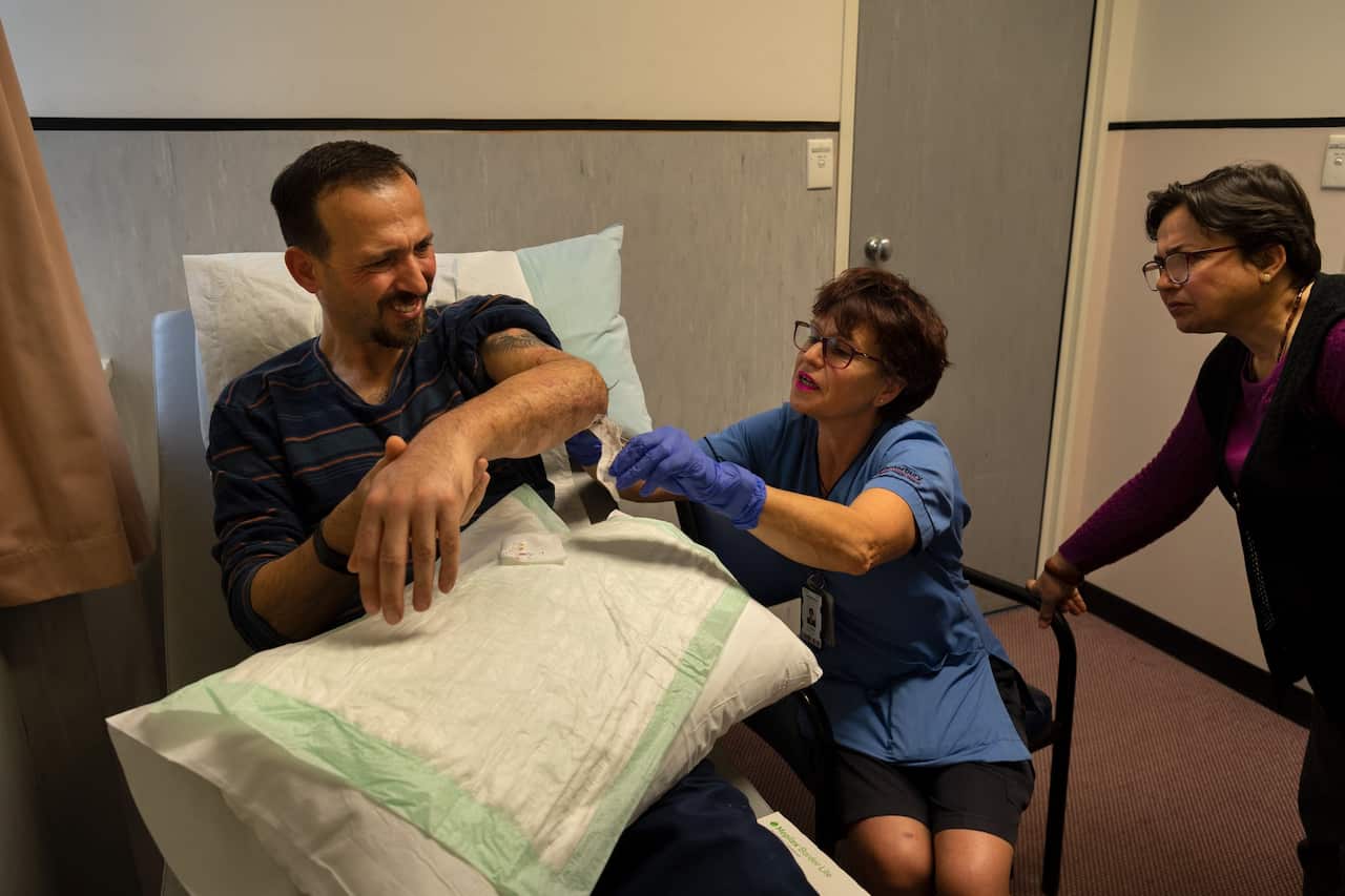 Mr. Atacocugu had his bandages removed by a nurse as his sister, Sengul Atacocugu, watched at Christchurch Hospital last week.