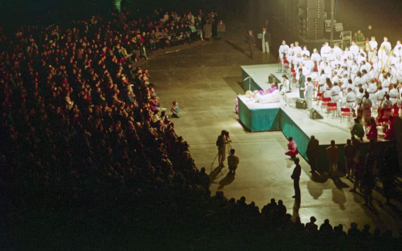 Shoko Asahara, leader of the cult group Aum Shinrikyo, sits on a throne in the middle of the stage during a meeting with his followers in Moscow in 1994.