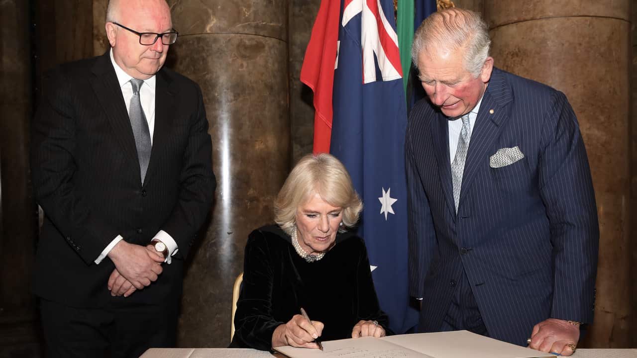 The Prince of Wales and The Duchess of Cornwall sign the visitors book.