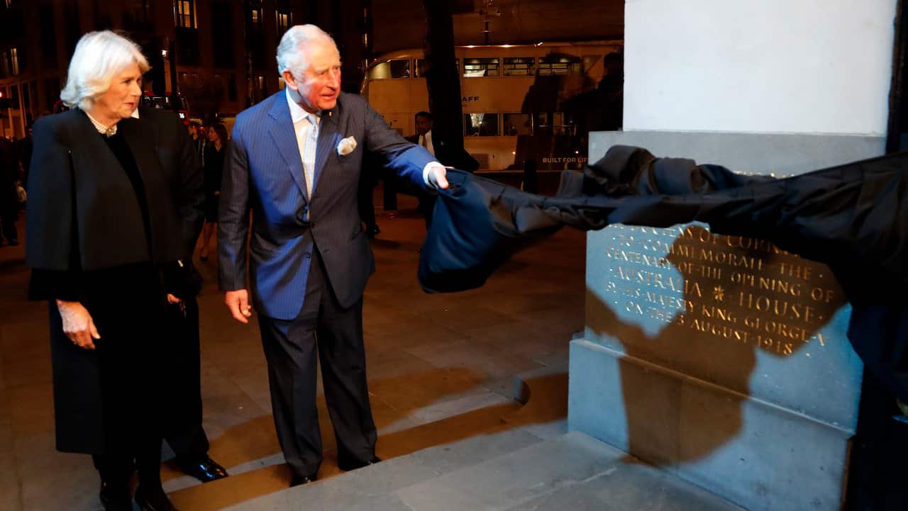 Britain's Prince Charles and Camilla, the Duchess of Cornwall, unveil a stone engraving that commemorates the centenary.