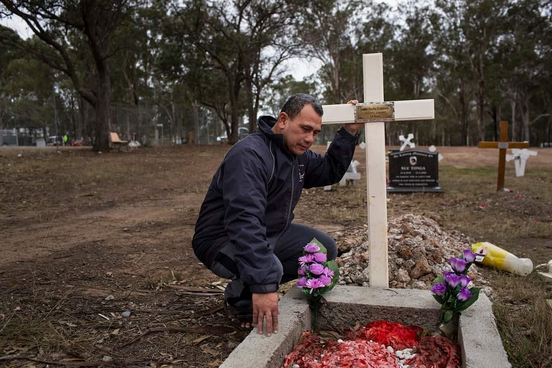 Vaea Togatuki visits the grave of his son Junior, who died in 2015 in an Australian prison, held by immigration officials after finishing his sentence, in Riverstone, Australia.