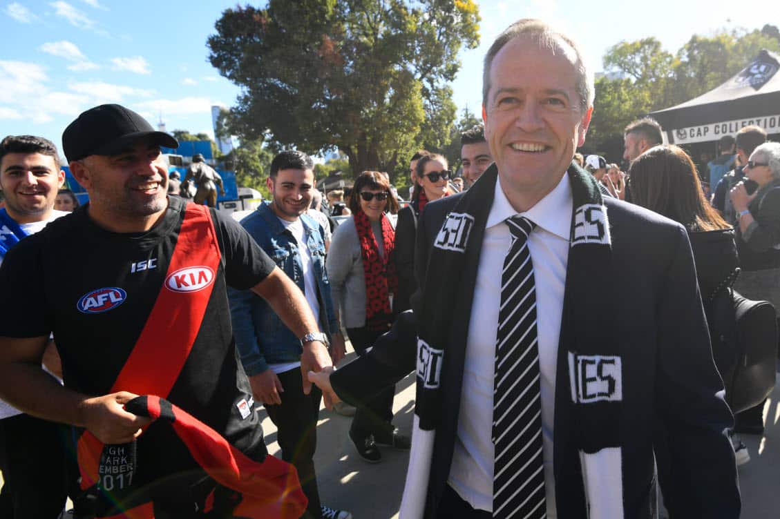 Australian Opposition Leader Bill Shorten speaks to a fan as he arrives to watch the ANZAC Day game between Essendon and Collingwood at the MCG in Melbourne, Thursday, April 25, 2019 (AAP)