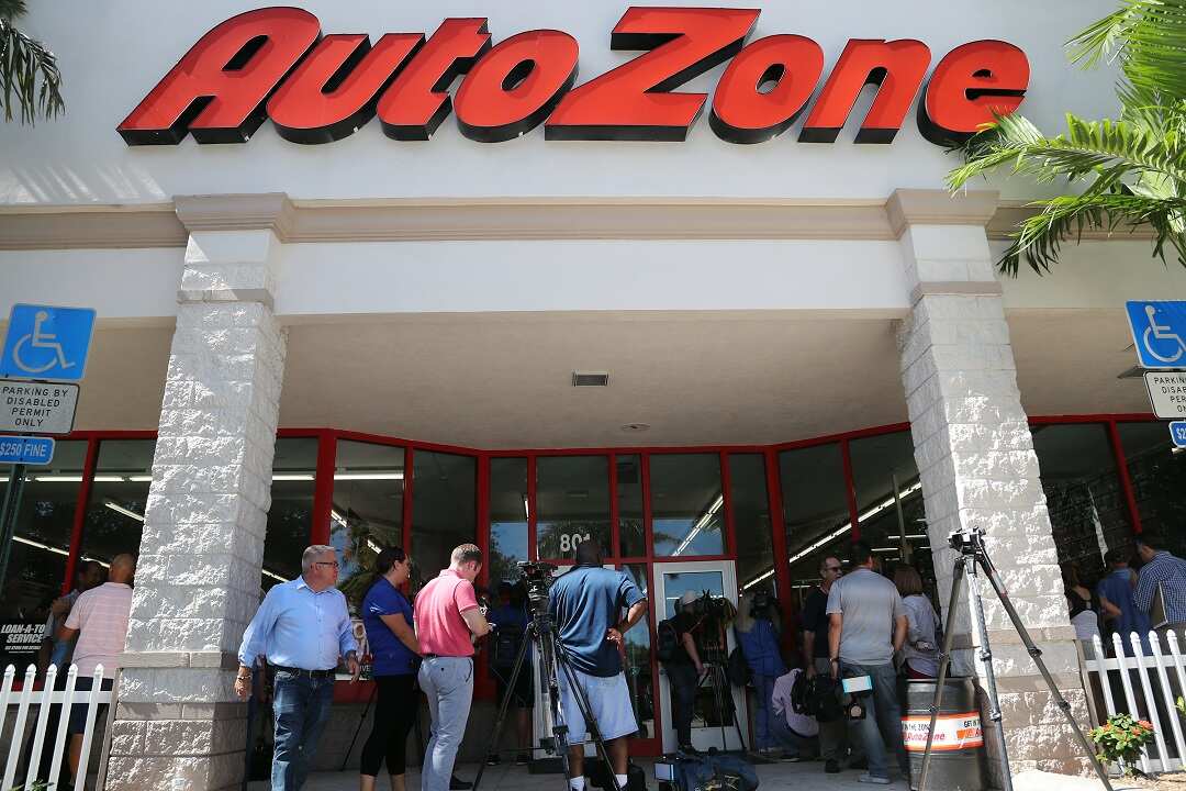 Reporters gather in front of the AutoZone store where Cesar Sayoc Jr., 56, was arrested.