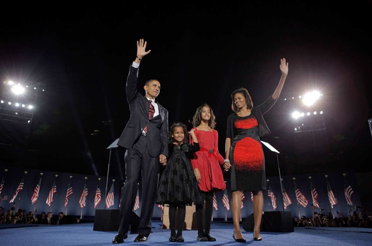 In this Nov. 4, 2008 file photo, Barack Obama, left, his wife Michelle Obama, right, and two daughters, Malia and Sasha wave to the crowd (AAP)