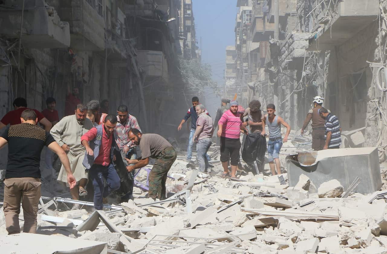 Syrians inspect the damage at the site of an airstrike staged by Russian army in the opposition-controlled Bustan al-Qasr neighborhood of Aleppo, Syrian on October 11, 2016.