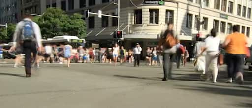  People walking across a busy intersection
