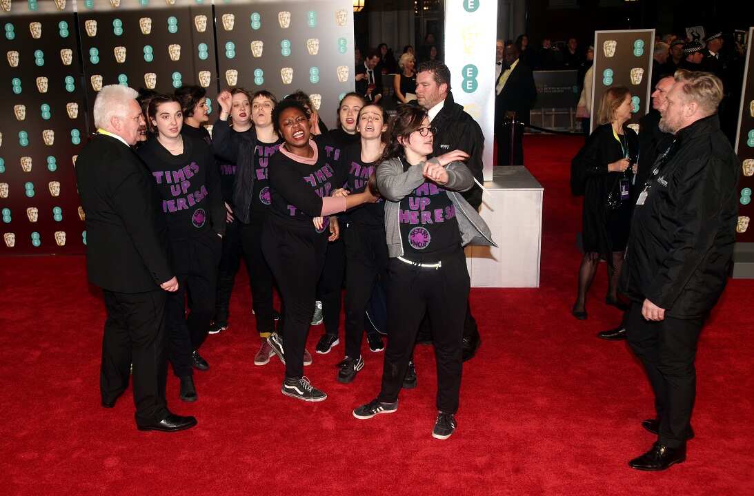 Time's Up campaigners storm the red carpet wearing tops reading 'Times Up Theresa' at the EE British Academy Film Awards held at the Royal Albert Hall.