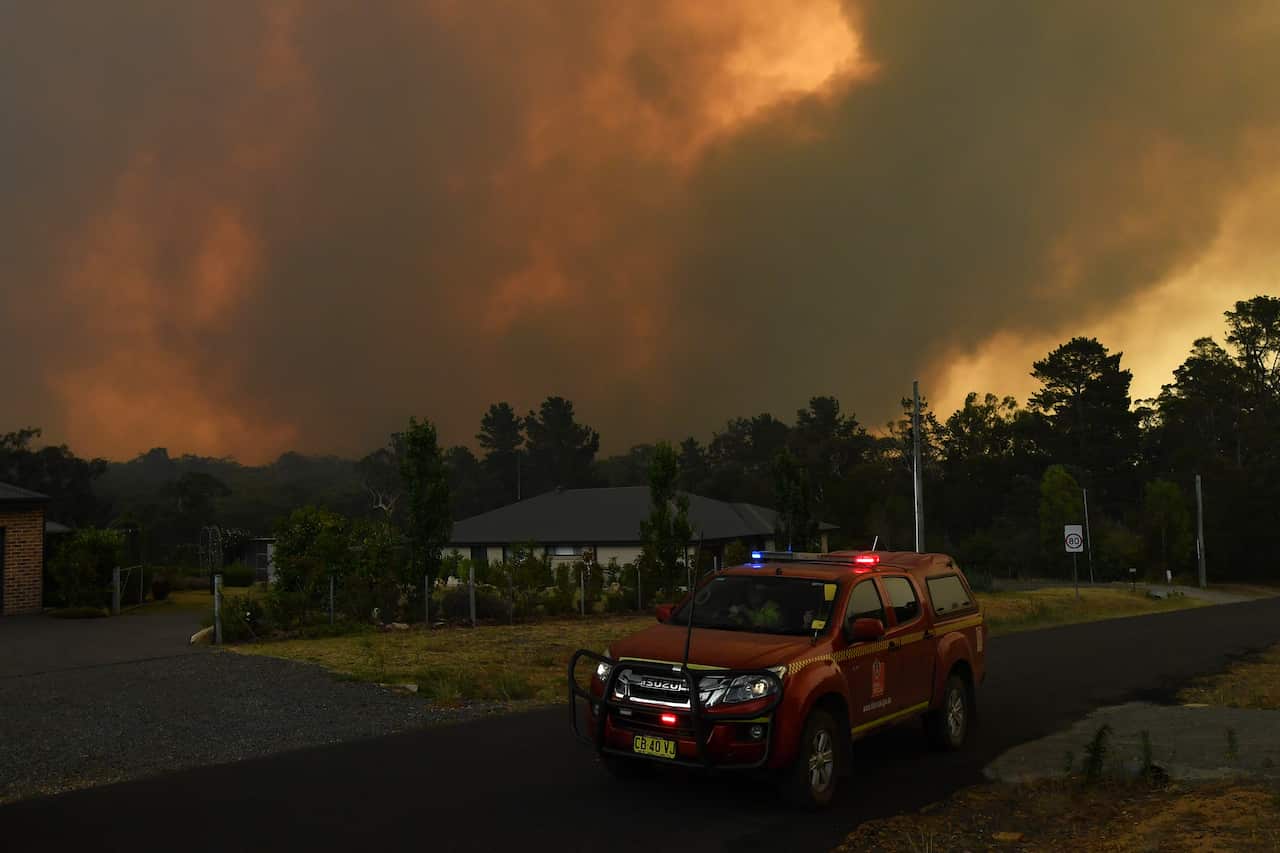 Rural Fire Service (RFS) crews prepare for the Green Wattle Creek Fire as it threatens homes in Yandeera.