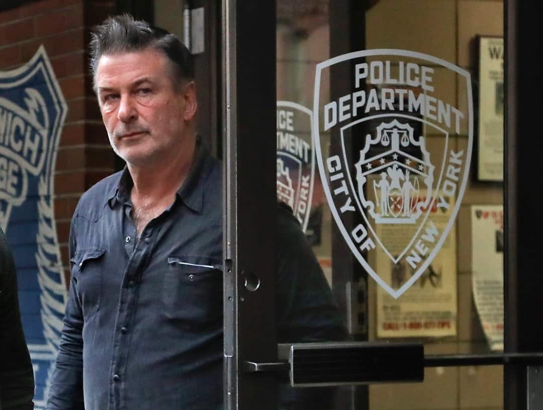 Actor Alec Baldwin walks out of a New York Police Department precinct after allegedly punching a man in the face.