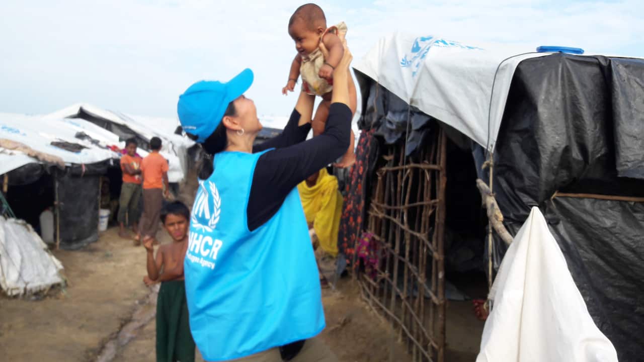 Ghedini-Williams holds up a baby amid the make-shift Rohingya camps. 