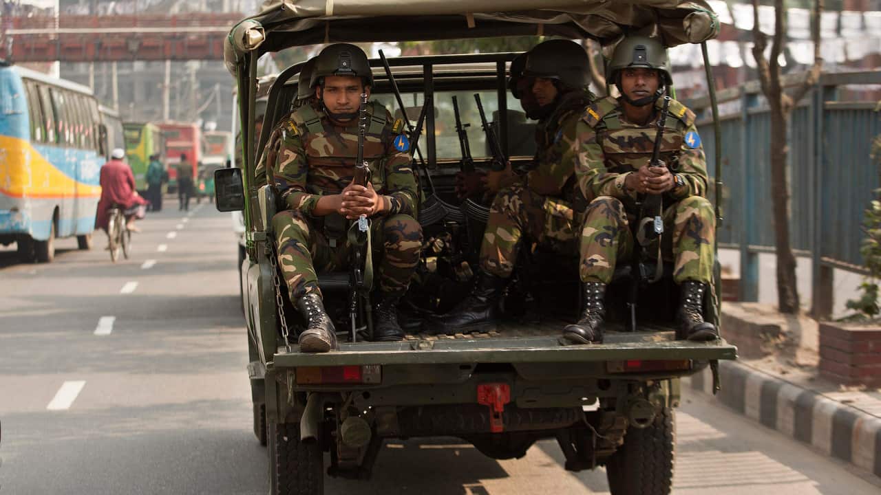Bangladeshi army soldiers sit inside a vehicle as they patrol the streets on the eve of the general elections in Dhaka, Bangladesh.