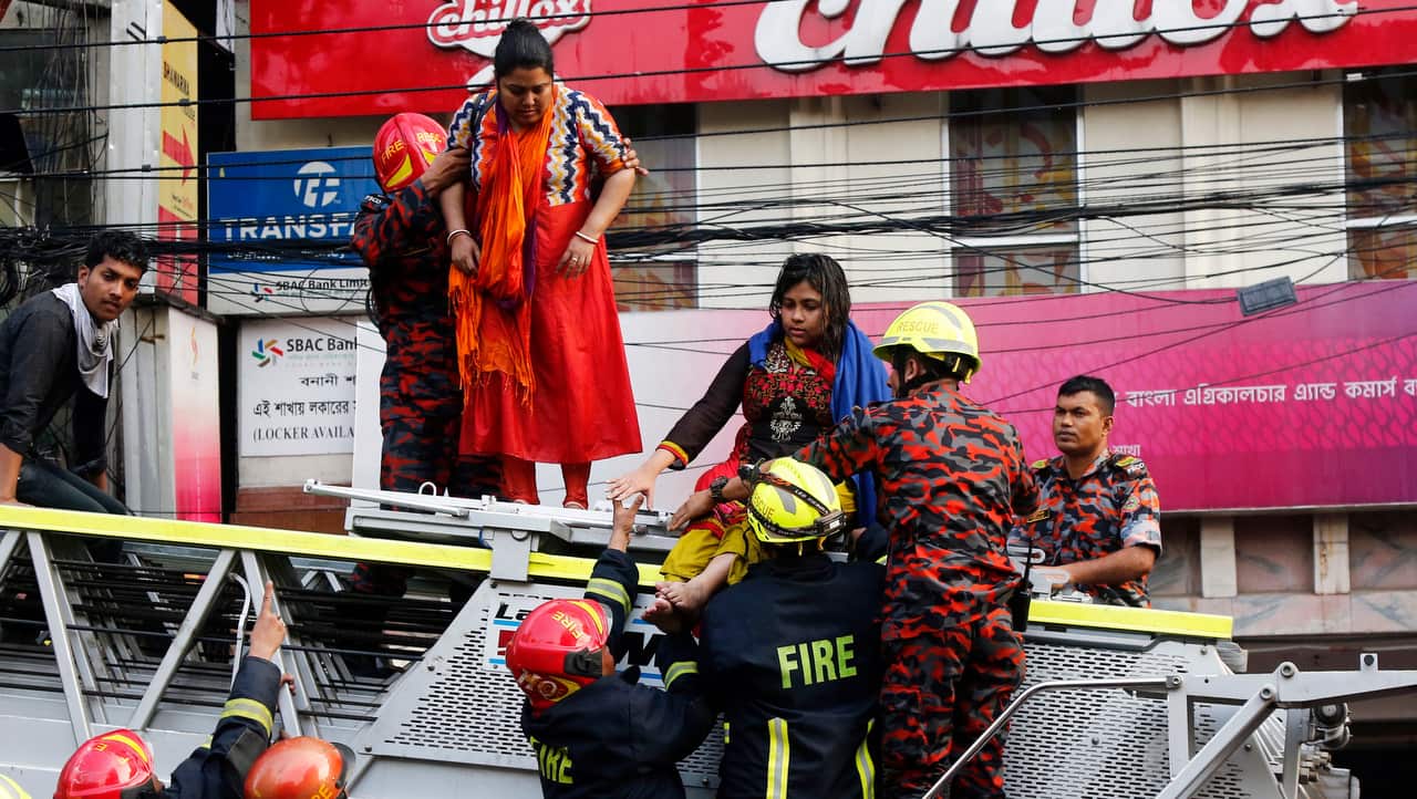 Firefighters rescue people from a burning high-rise building in Banani area of Dhaka, Bangladesh.