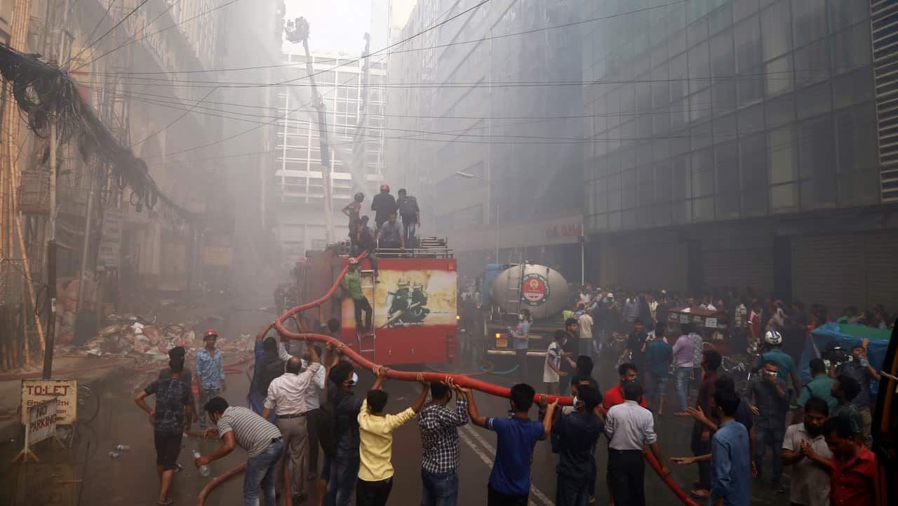 Firefighters try to extinguish the fire.