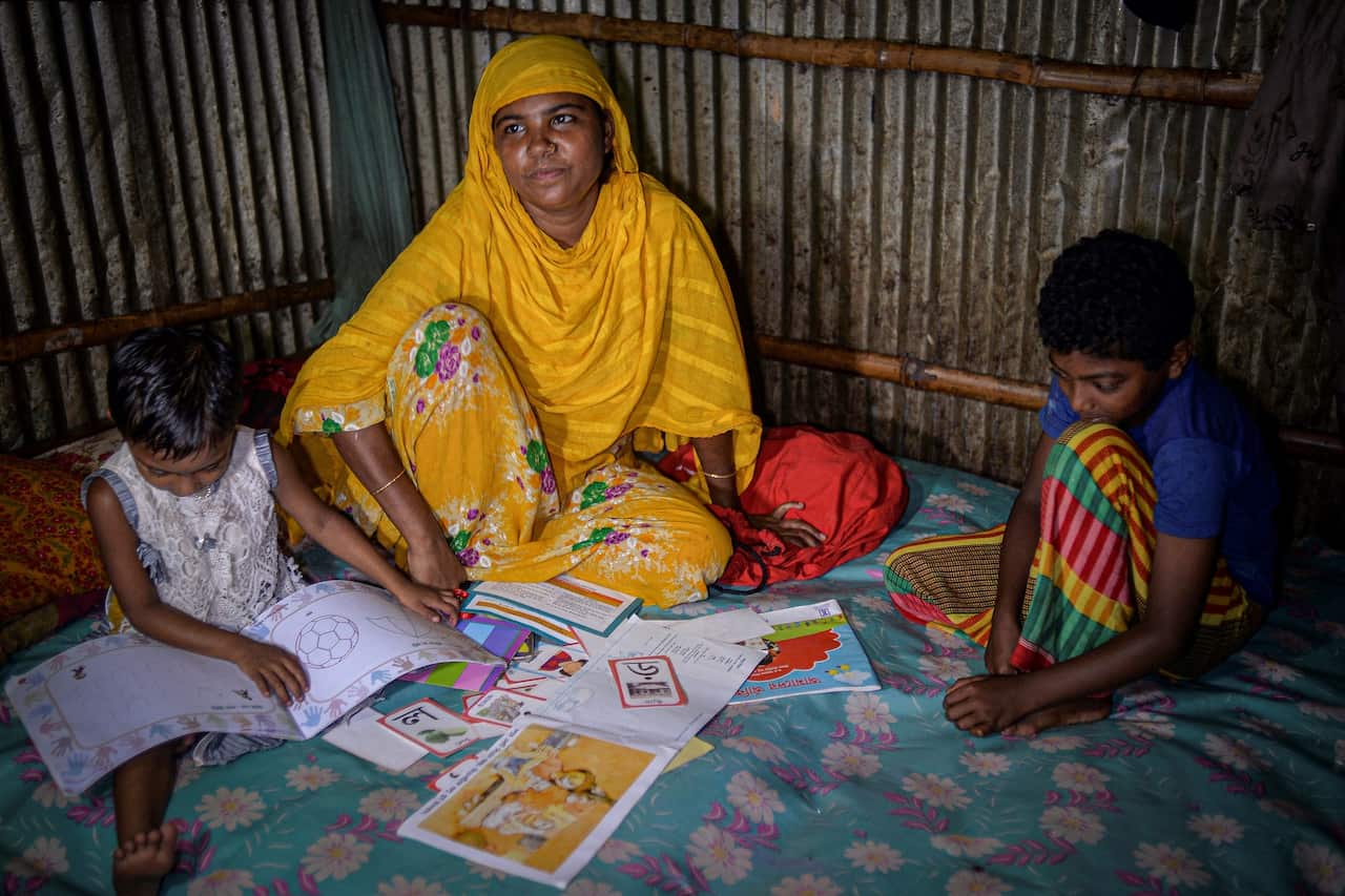 Bibi Salma sits with her children in Dhaka.