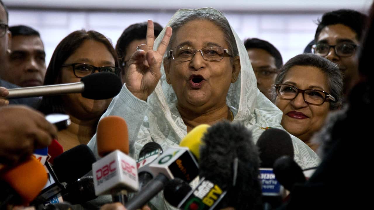 Bangladesh Prime Minister Sheikh Hasina flashes a victory sign as she speaks to the media persons after casting her vote in Dhaka, Bangladesh.