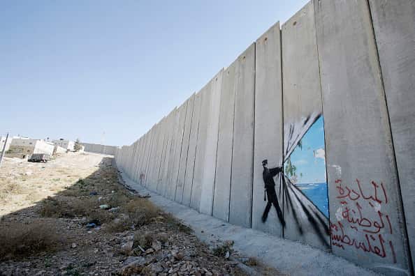 Banksy art on Israel's highly controversial West Bank barrier in Abu Dis in 2005. Banksy has made a name for himself with provocative images.
