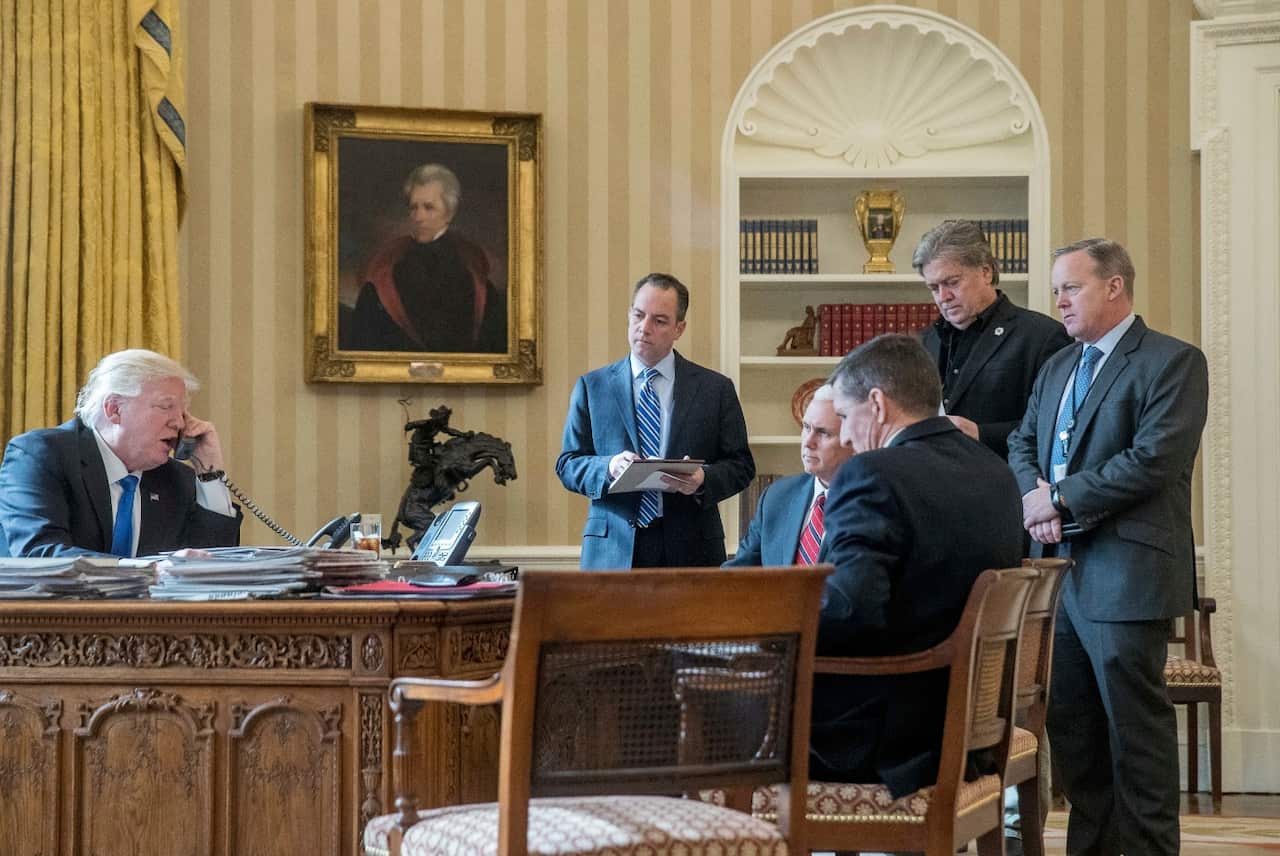 President Donald Trump, along with current and former staffers, including Steve Bannon (second from right) (AAP)