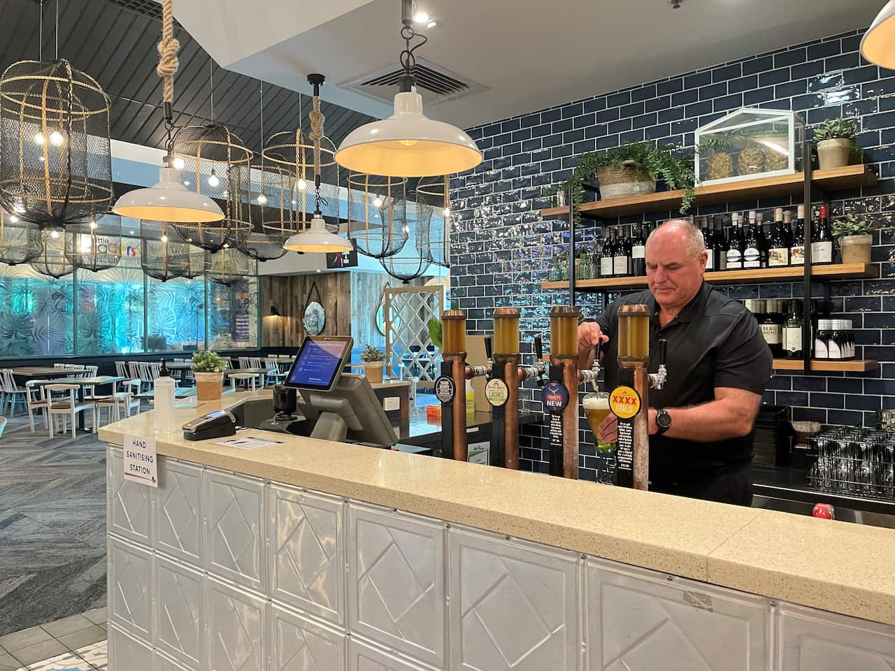 C.ex Club CEO John Rafferty pours a beer at the bistro.