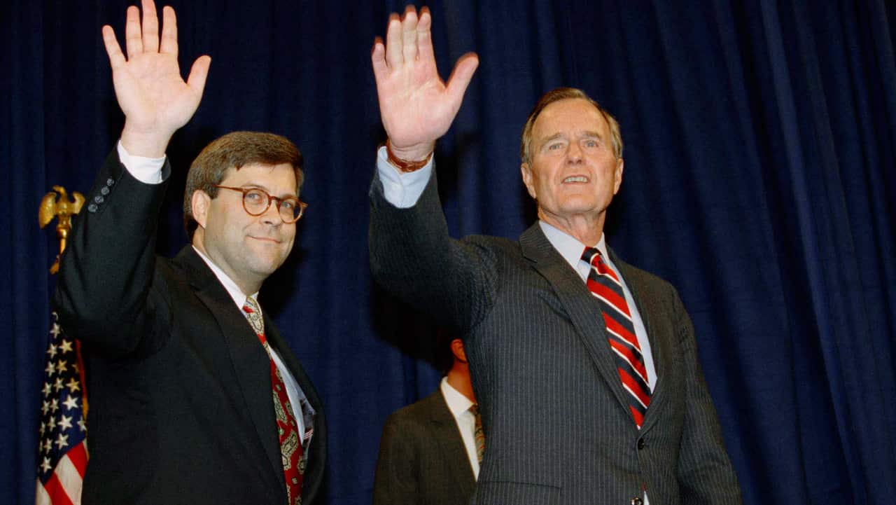 In this photo dated November 26, 1991 President George H.W Bush, right, and William Barr wave after Barr was sworn in as the new Attorney General.