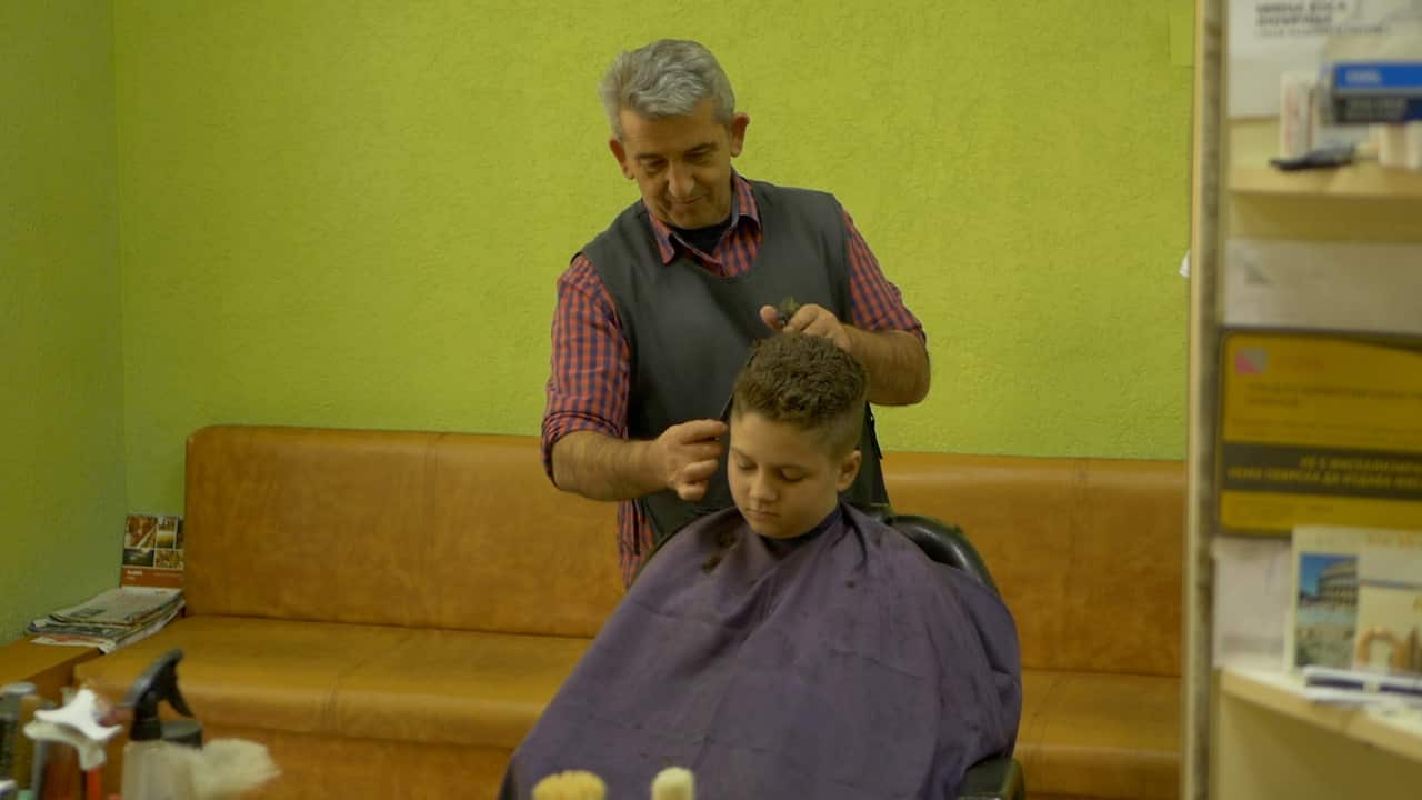 Barber Remzi Osmani takes the pulse of the debate while working with his clients in Skopje’s outskirts.