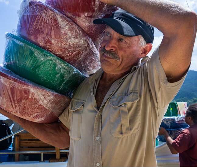 Barry Kirby distributing Baby Bundles to mothers in Papua New Guinea (supplied) 