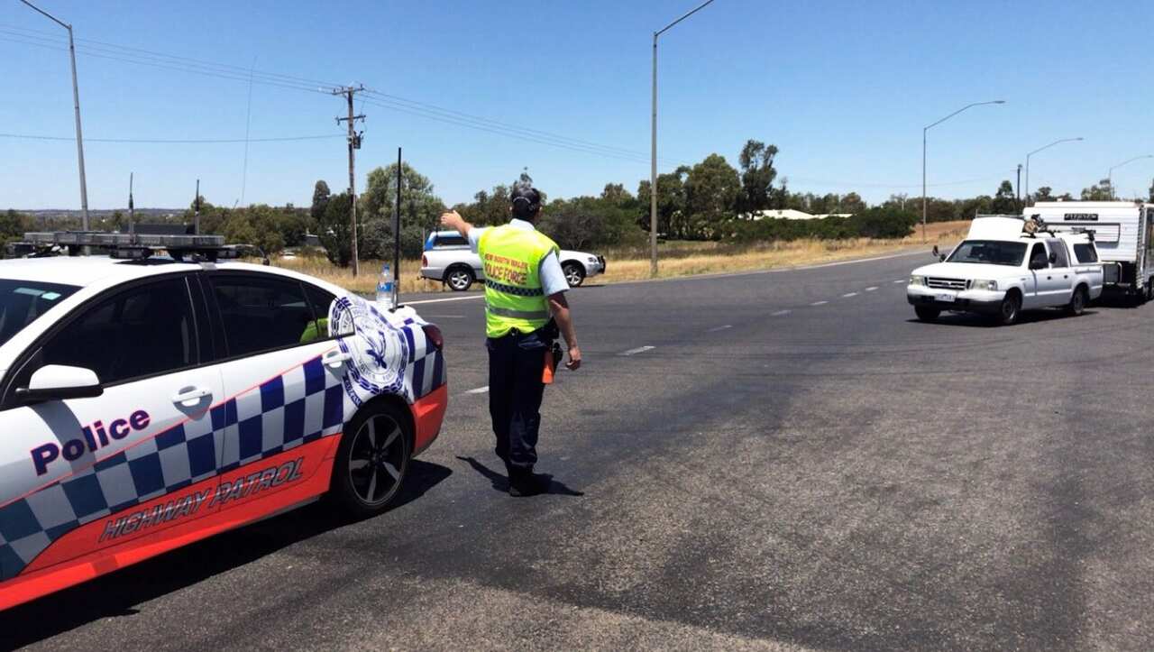 A NSW Police officer directing traffic at the scene of the crash (Lily Cardis/Twitter)