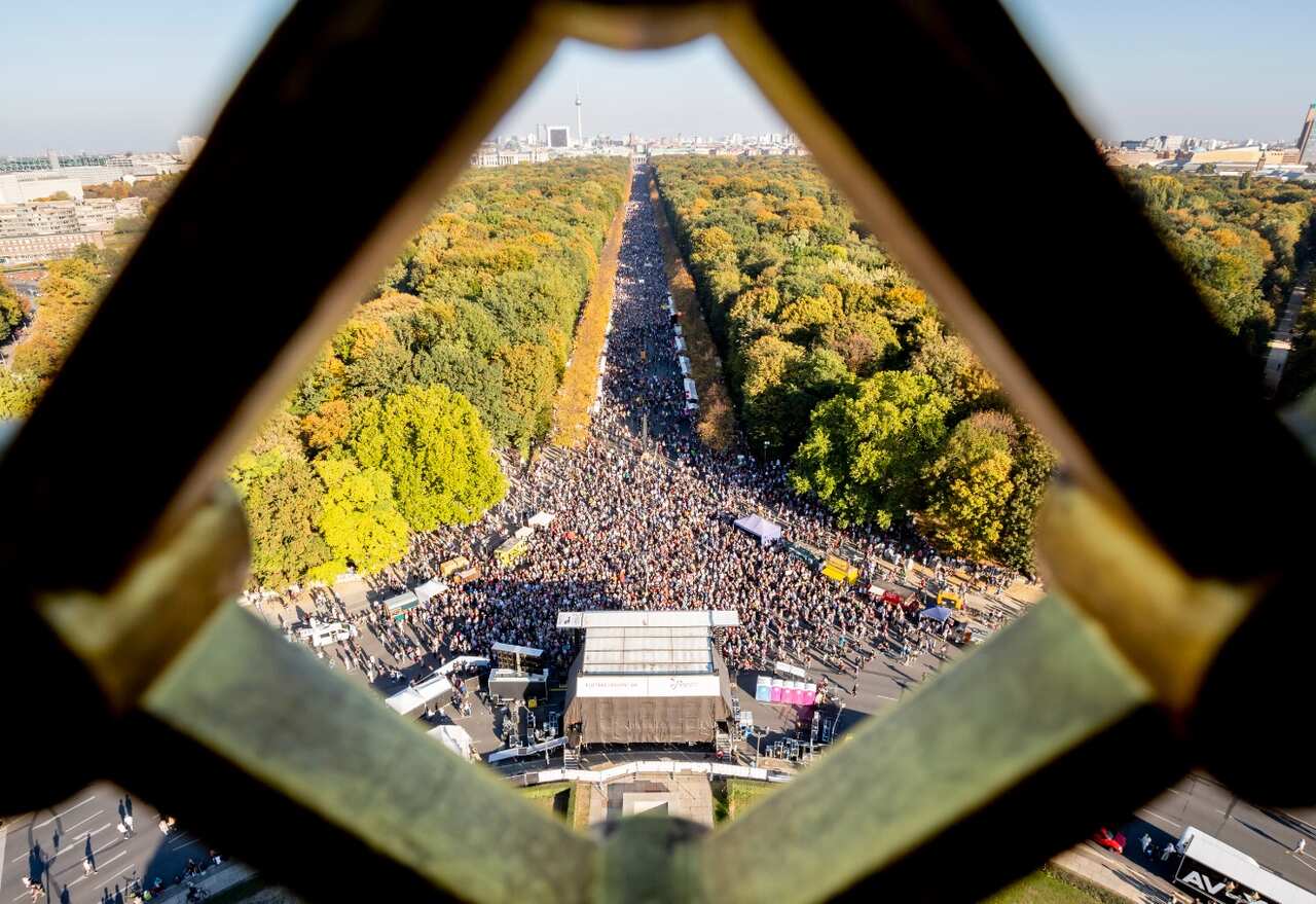 A picture taken from the the Berlin Victory Column shows protesters marching through Strasse des 17