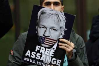 An Assange supporter holds a "FREE ASSANGE" banner up during a US protest. 