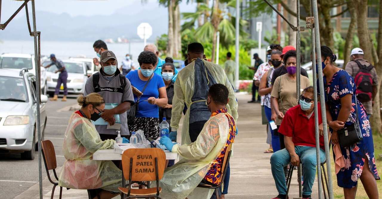 Residents queue up for their vaccine dose outside a vaccination centre in Suva.